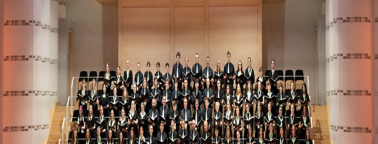 Student on laptop University choir in the choir gallery of the concert hall